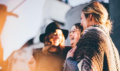 Drei Frauen lachen zusammen